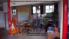 The living room area In winter, only a part of the area is heated with the pellet stove, creating a cosy atmosphere and connecting the family