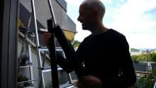 Maiken’s husband Chris with wood salvaged from neighbours’ old kitchen. It’s for the winter shelter they are building